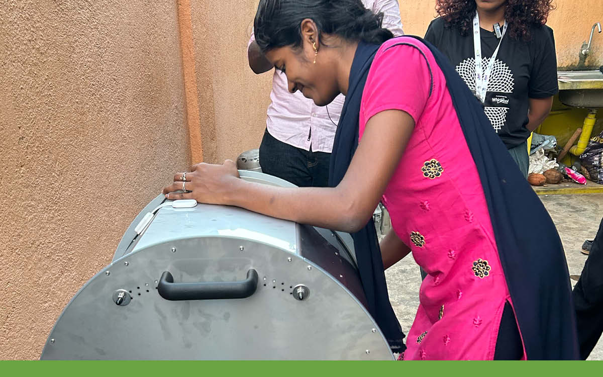 Woman in India learning to use the manual washing machine